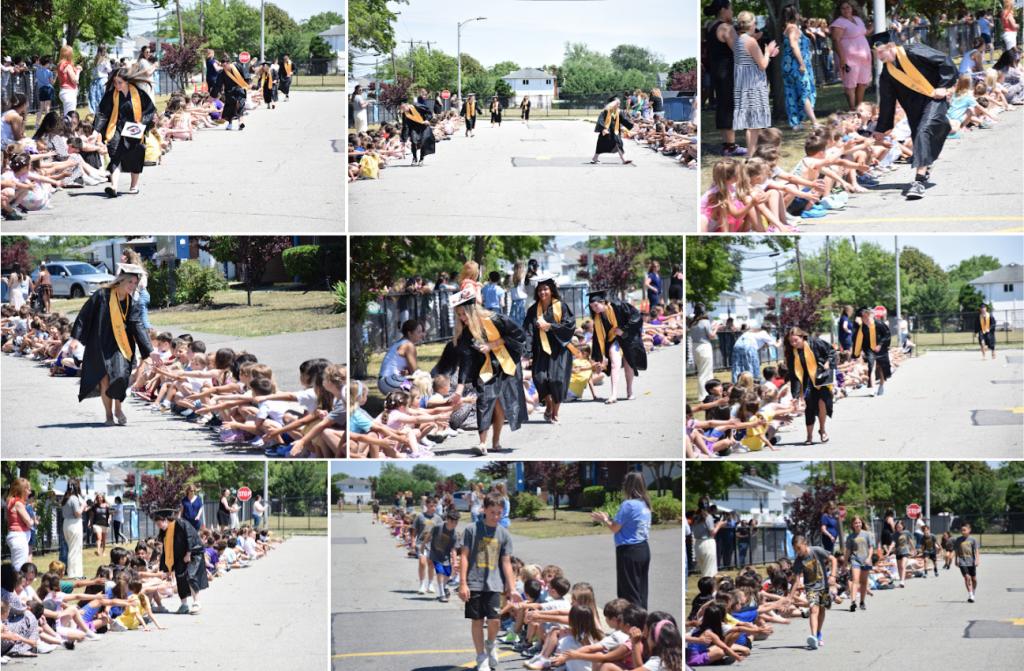 students in graduation robes walking down street clapping